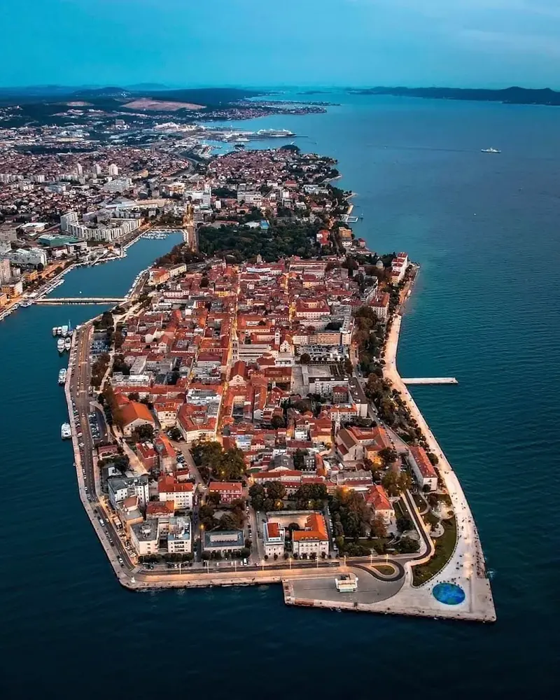 Zadar&rsquo;s old town on its peninsula, seen from the air at dusk